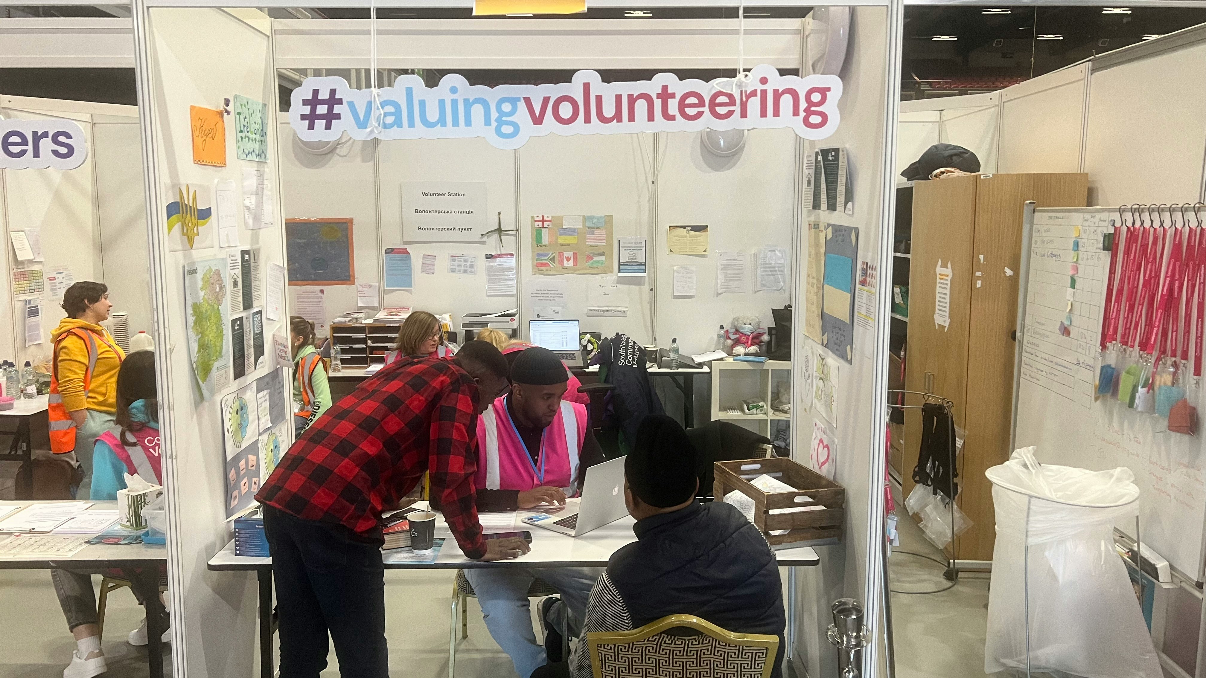 Volunteers engaging with community members at outreach event